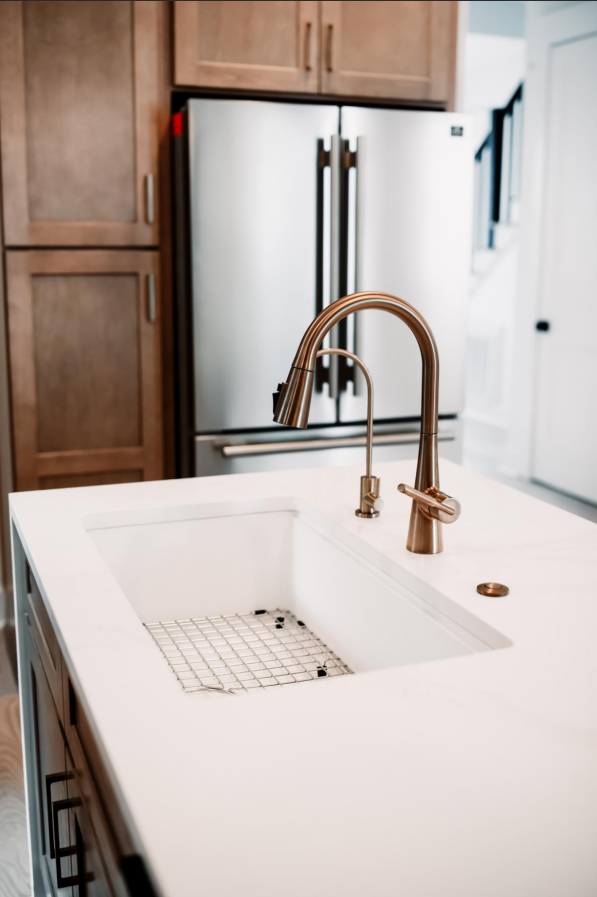 Kitchen island with undermount sink and brass faucet