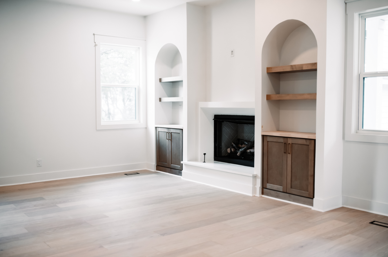 Living room with fireplace and built-in arches